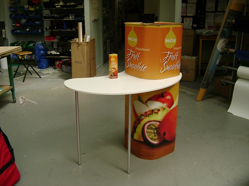 Portable demonstration table in shape of drink container